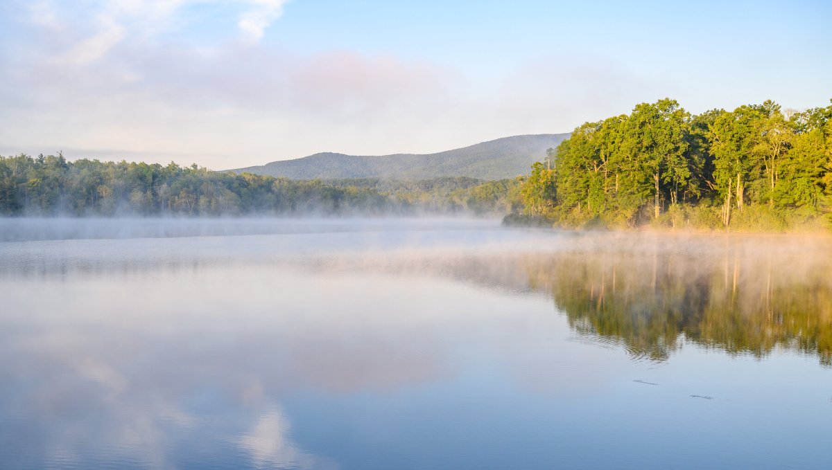 Price Lake with mist over water and trees and mountains in background