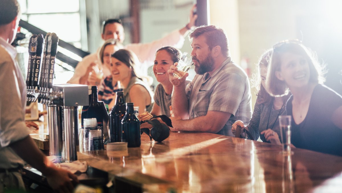 People sitting at bar drinking cider at Bold Rock