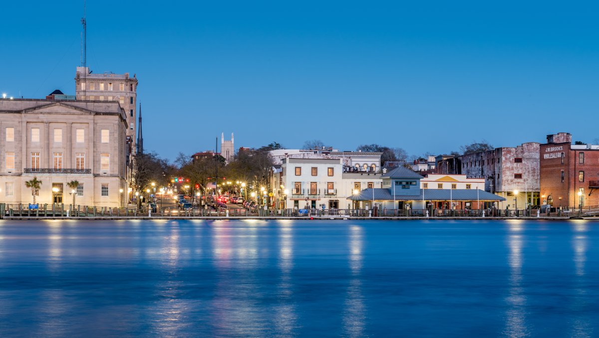 View of Wilmington Riverwalk at dusk across Cape Fear River