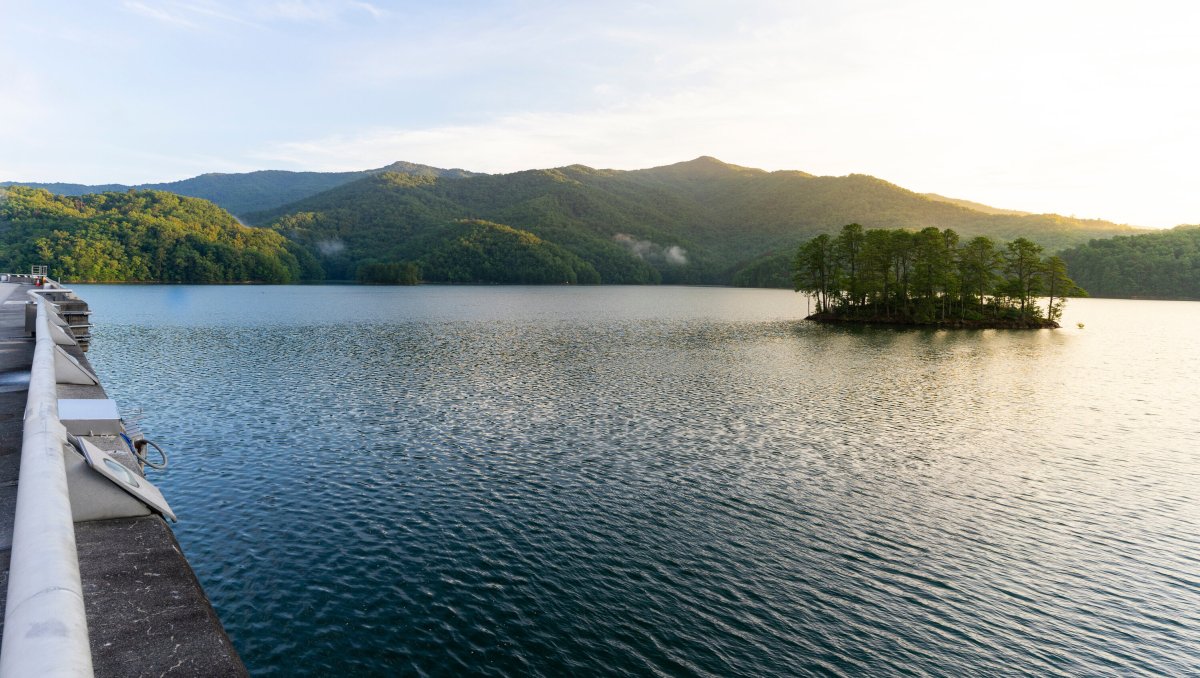 Fontana Lake with small island in center with mountains in background.