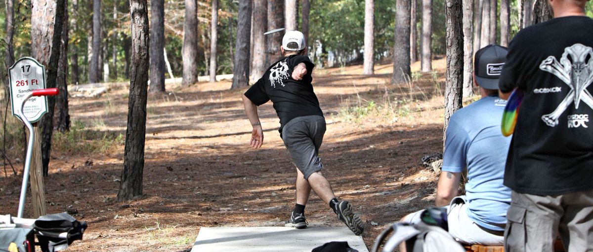 man playing disc golf at Reservoir Park