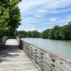 Wooden Roanoke River Boardwalk with river to right on sunny day.