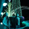 Two women wearing masks looking at Christmas lights at Winter Wonderlights at nighttime