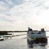 Pontoon of friends taking a tour through oyster farm.