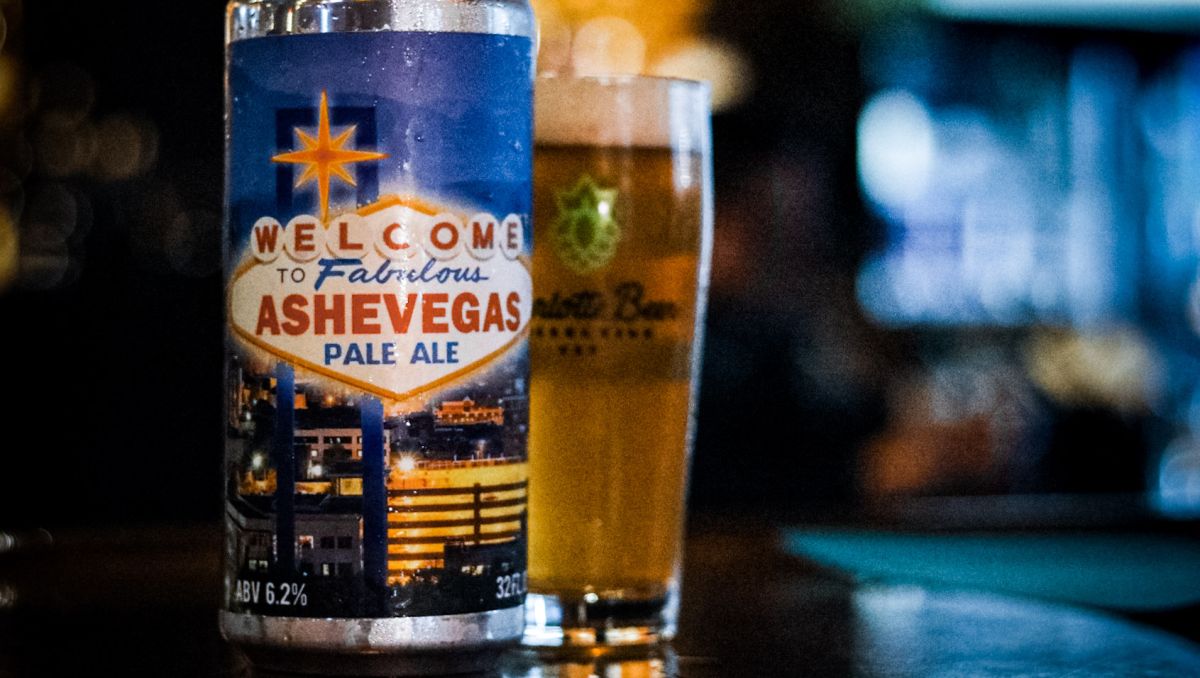 Ashevegas beer can displayed in front of pint of beer