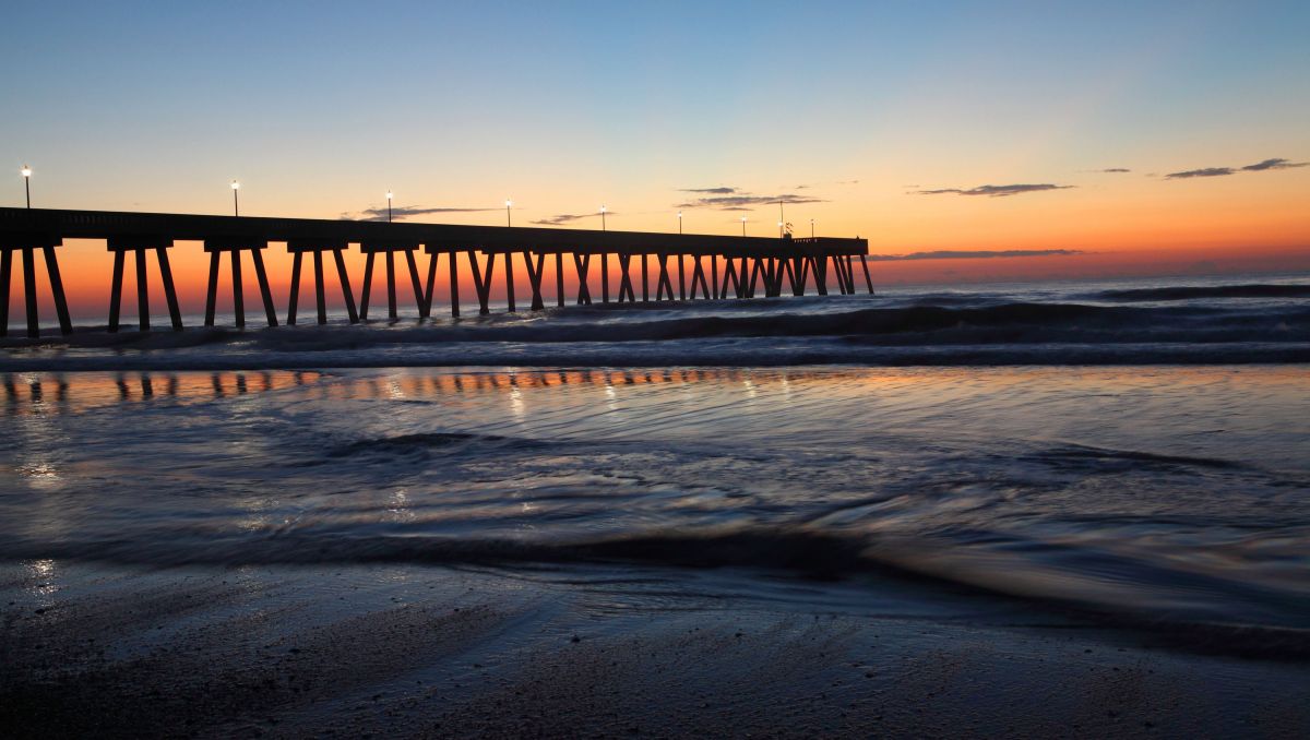 Johnnie Mercers Pier jutting into the ocean during a sunrise