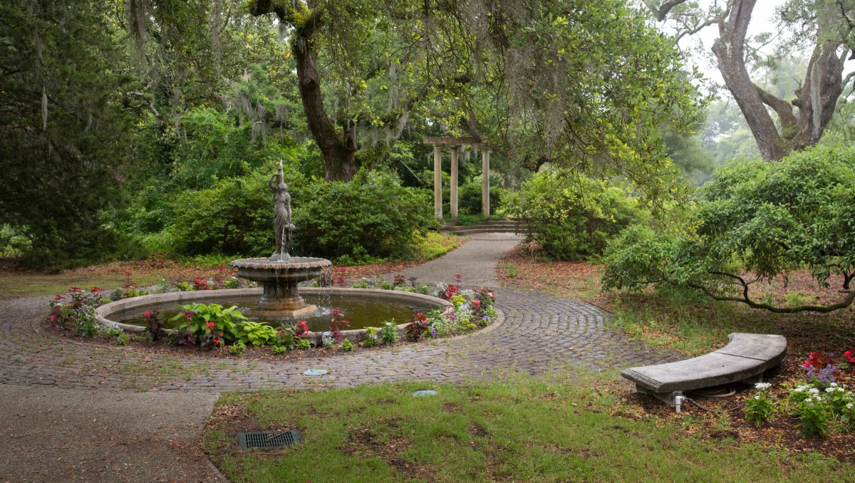 Fountain in the Spring Garden with trees and spanish moss on cloudy day at Airlie Gardens in Wilmington