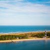 Aerial view of lighthouse, national seashore and water on both sides of land during daytime