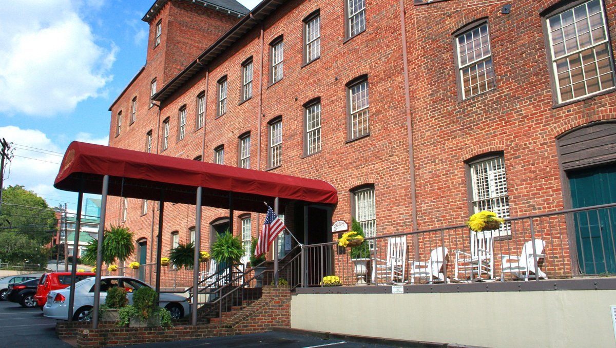 Exterior of brick Brookstown Inn with red awning over entrance