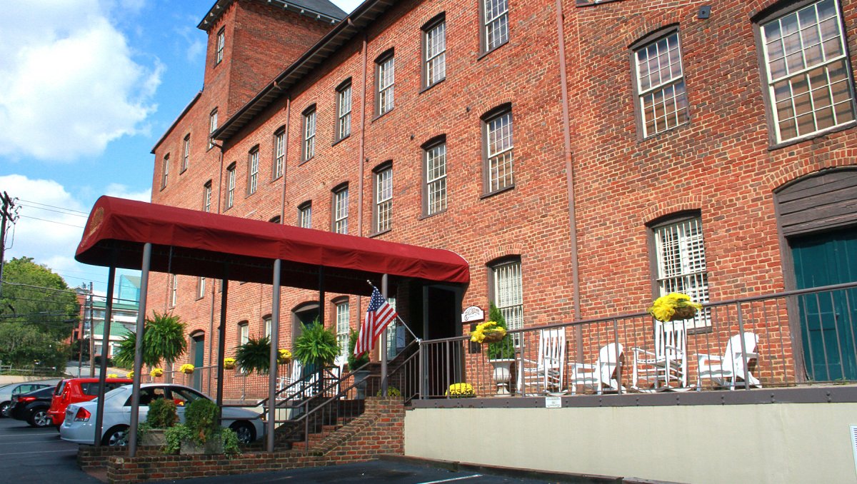 Exterior of brick Brookstown Inn with red awning over entrance