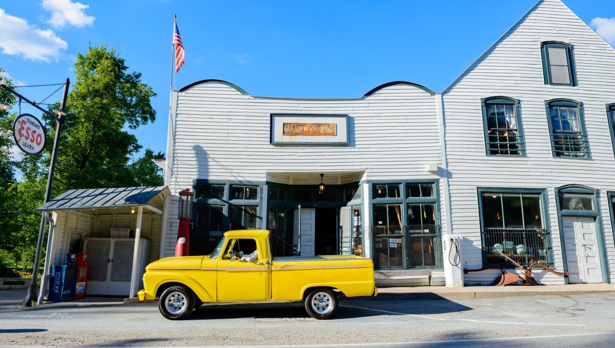 Exterior of old general store with yellow truck parked in front