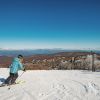 Woman skiing down mountain at Beech Mountain on bright winter day