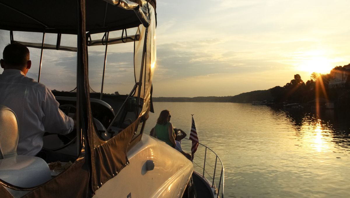 Man and woman aboard boat while watching sunset on Lake Hickory