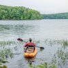 Man in kayak fishing on Badin Lake in Uwharrie National Forest, North Carolina.