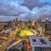 Long-range aerial view of Uptown Charlotte at dusk, including Truist Field.