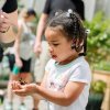 Little girl holding butterfly at exhibit at North Carolina Zoo