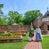 Two constumed interpreters standing in gardens at Tryon Palace