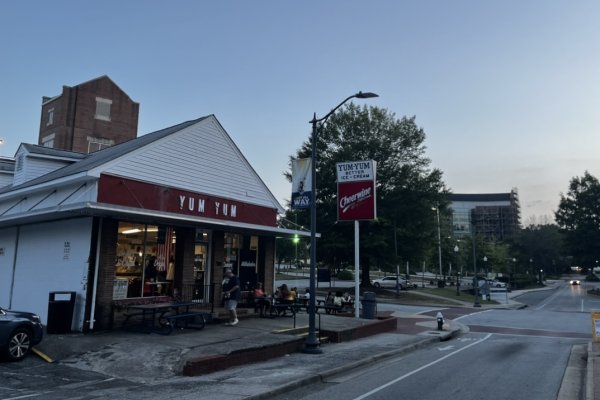 Exterior of ice cream shop on corner of street at dusk