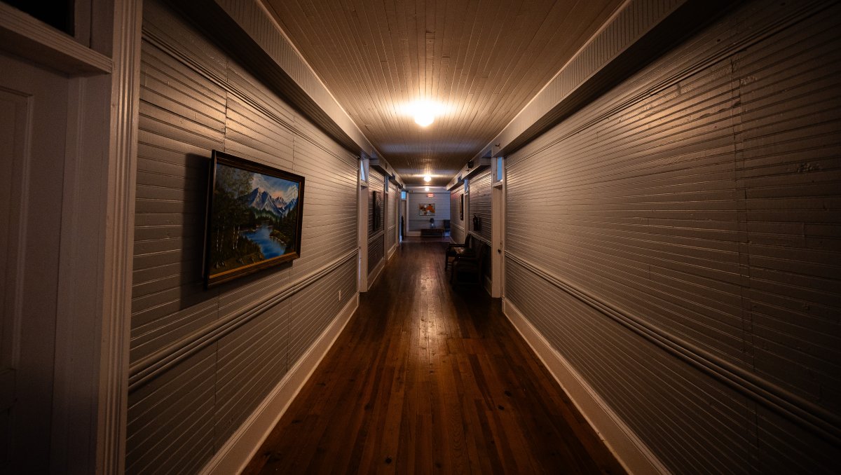 Spooky hallway of Balsam Mountain Inn with moody lighting.