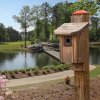 Birdhouse yardage marker on pretty golf course with pond and trees