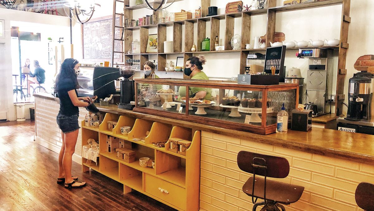 Woman wearing mask ordering a drink at the counter of the Gilded Pear Brew House in Smithfield